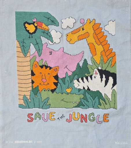 cross-stitch of cartoony animals with the phrase Save the Jungle below